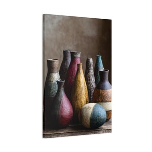 May include: A canvas print featuring a collection of decorative vases in various shapes, sizes, and colors. The vases are arranged on a wooden surface, with a neutral background. The color palette includes red, yellow, blue, and brown.