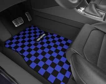 May include: Black and blue checkered car floor mat with the text "ZERO CULTURE" in white. The mat is rectangular and fits in the driver's side of a car, near the pedals and seat.