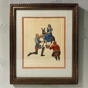 May include: A framed print featuring a central figure in a blue dress riding a donkey, with a figure in silver armor kneeling on the left and a figure in a red shirt kneeling on the right, both holding hats. The artwork is in a gold ornate frame.