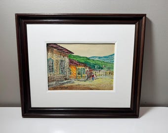 15インチ×13インチの額装済みミクストメディア作品。丘と海に囲まれた町を描いたサイン入り。