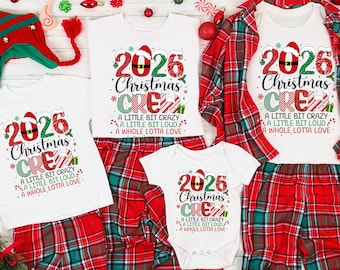 May include: White t-shirts and a baby bodysuit featuring the red and green text 2026 Christmas CREW A LITTLE BIT CRAZY A LITTLE BIT LOUD A WHOLE LOTTA LOVE, paired with red and green plaid pajama pants and a matching elf hat with red pom-poms.