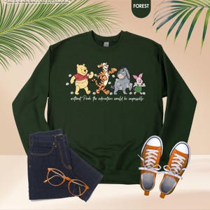 Puede incluir: Una sudadera verde bosque con un dise&ntilde;o de Winnie the Pooh y sus amigos. El dise&ntilde;o incluye a Pooh, Tigger, Eeyore y Piglet, con el texto "without Pooh the adventure would be impossible." La sudadera se combina con vaqueros azules y zapatillas naranjas.