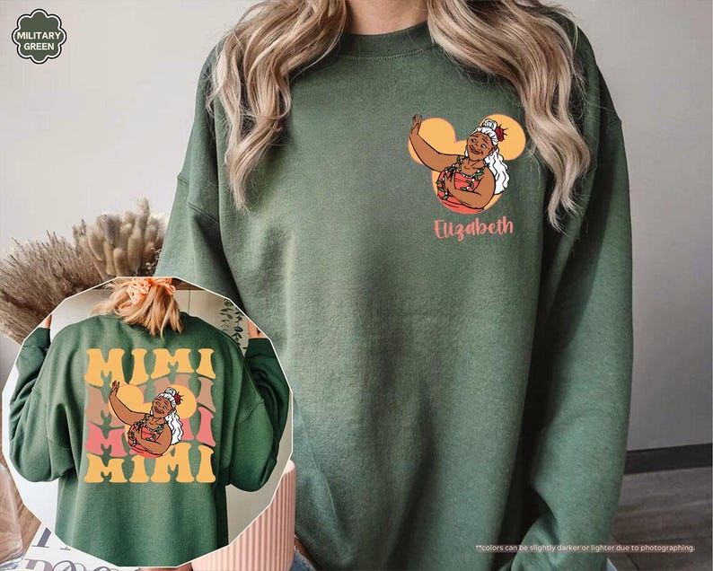May include: Military green sweatshirt with a graphic of a woman in a red and pink floral top, with the name "Elizabeth" below. The back of the sweatshirt has the word "MIMI" in large, retro-style lettering, with the same graphic.