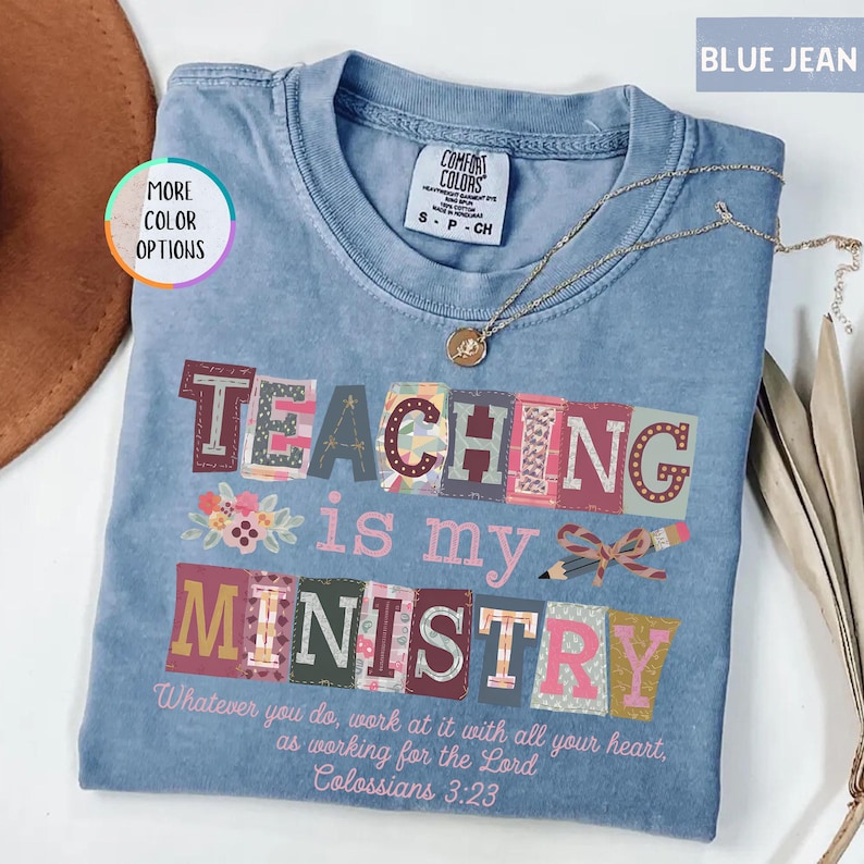 Pu&ograve; includere: T-shirt blu jeans con le parole "TEACHING is my MINISTRY" in lettere a blocchi colorate. La maglietta presenta anche il testo "Whatever you do, work at it with all your heart, as working for the Lord Colossians 3:23". Una collana d'oro &egrave; appoggiata sulla maglietta.