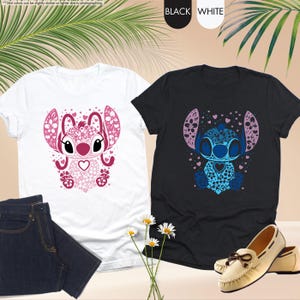 May include: Two t-shirts, one white and one black, each featuring a stylized cartoon character design. The white shirt has a pink design, while the black shirt has a blue design. The shirts are paired with jeans and shoes.