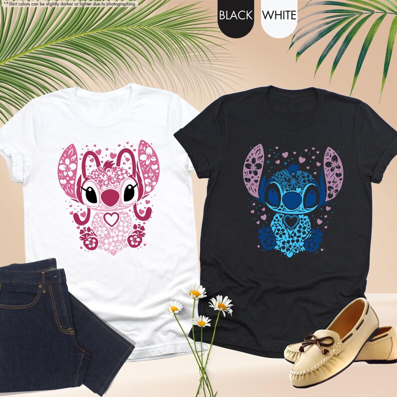May include: Two t-shirts, one white and one black, each featuring a stylized cartoon character design. The white shirt has a pink design, while the black shirt has a blue design. The shirts are paired with jeans and shoes.