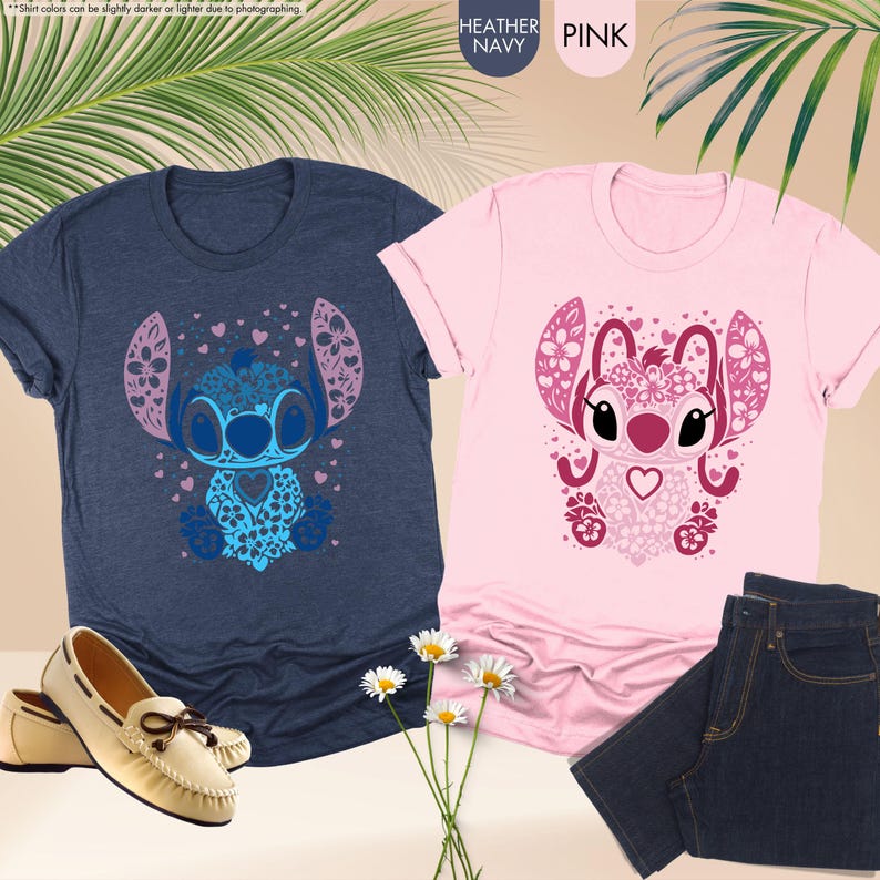 May include: Two t-shirts, one heather navy and one pink, featuring a decorative Stitch design. The navy shirt is paired with cream-colored loafers, while the pink shirt is next to a pair of dark blue jeans. The image also includes daisies.