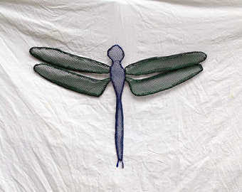 May include: A green and blue wire dragonfly sculpture with a mesh-like design. The dragonfly is suspended against a white background.