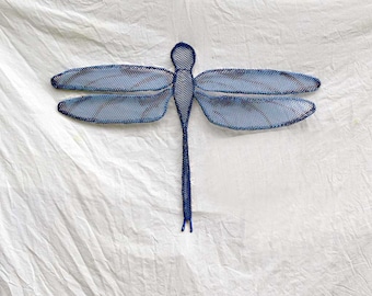 May include: A blue metal dragonfly sculpture with a wire mesh body and wings. The dragonfly is suspended against a white background.