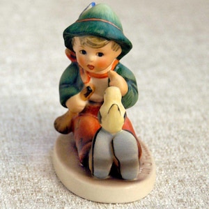 May include: A set of three ceramic mugs with a speckled, matte finish. The mugs are in shades of cream, light gray, and dark gray. Each mug has a simple, minimalist design and a rounded handle.