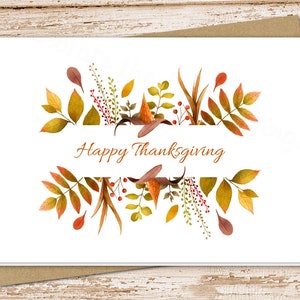 May include: A white card with a watercolor illustration of autumn leaves and the text "Happy Thanksgiving".