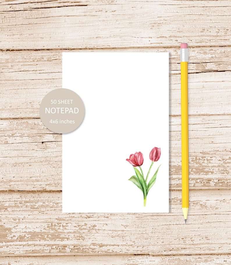 Pode incluir: Um bloco de notas branco com uma ilustra&ccedil;&atilde;o de tulipa rosa. O bloco de notas mede 10,16 x 15,24 cm e tem 50 folhas.