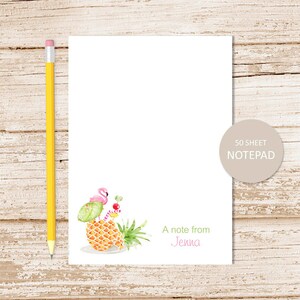 May include: A 50-sheet notepad with a pink flamingo, a green umbrella, and a pineapple with a red and white striped straw. The notepad says "A note from Jenna".