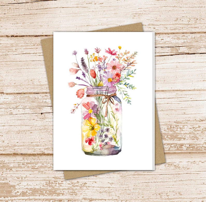 May include: A watercolor painting of a mason jar filled with a bouquet of colorful wildflowers. The flowers are in shades of pink, purple, yellow, and white. The jar is tied with twine.
