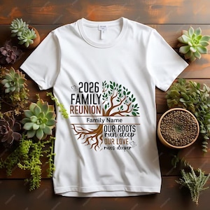 May include: White t-shirt with a family reunion design. The design includes the text "2026 Family Reunion", a tree graphic, and the phrase "Our Roots Run Deep, Our Love Runs Deeper". The shirt is surrounded by succulents.