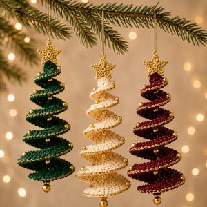 May include: Three spiral-shaped Christmas tree ornaments made of crocheted yarn in dark green, cream, and deep red. Each ornament features a gold crocheted star at the top, small gold beads along the spiral edges, and a gold bead at the base.