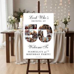 以下が含まれることがあります： 木製のイーゼルに立てられた白い看板。テキスト「Look Who's Shining At 50」と「Welcome To Isabella's 50th Birthday Party!」が書かれています。数字の50は写真で埋められています。日付10.12.2025が一番下にあります。