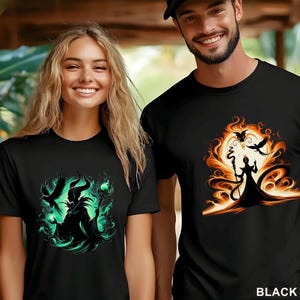 Puede incluir: Camisetas negras con dise&ntilde;os gr&aacute;ficos. Una camiseta presenta una ilustraci&oacute;n verde y negra de un personaje con cuernos, un bast&oacute;n y cuervos. La otra camiseta tiene un dise&ntilde;o similar en naranja y negro.