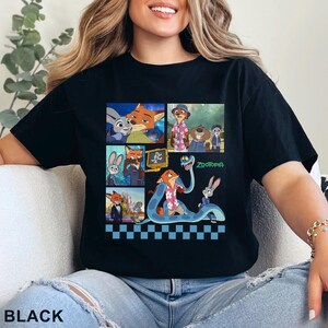 Pu&ograve; includere: T-shirt nera con un colorato collage di immagini del film d'animazione Zootropolis. Il design include personaggi come Nick Wilde e Judy Hopps, con la parola "Zootropolis" in verde. La parola "BLACK" &egrave; stampata in basso.