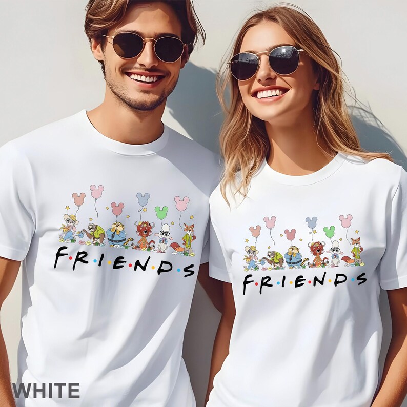 May include: White t-shirts featuring the word "FRIENDS" in a colorful font, with cartoon characters and Mickey Mouse-shaped balloons. The shirts are worn by two people. The word "WHITE" is at the bottom of the image.