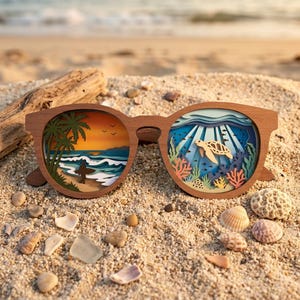 May include: Wooden sunglasses with a layered design depicting a beach scene and an underwater scene. The beach scene features a surfer, palm trees, and a sunset. The underwater scene shows a sea turtle, coral, and fish.