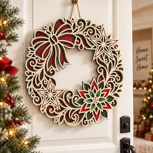 May include: A layered wooden festive wreath featuring intricate cutouts of a large bow, two five-pointed stars, and a central poinsettia flower. The design incorporates deep red and forest green accents against a natural light wood finish.