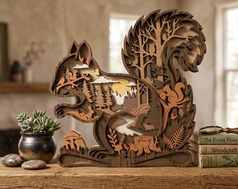 May include: A multi-layered wooden squirrel sculpture with a detailed forest scene carved within. The sculpture features a squirrel, trees, a river, and an owl. The color palette includes shades of brown, tan, and yellow, creating a natural and rustic aesthetic.