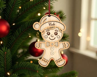 May include: A wooden gingerbread man Christmas ornament with the name "Cole" on the hat. The ornament is hanging on a Christmas tree with red ornaments and green needles.