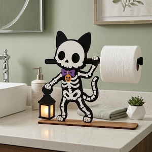 May include: A novelty toilet roll holder in the shape of a skeleton cat, perfect for Halloween. The black and white cat figure holds a roll of white toilet paper. It has a purple bow tie and a jack-o'-lantern on its chest. A small lantern sits on the base.