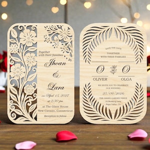 May include: Two wooden wedding invitations with floral cutouts. One features the names Jhoan and Lara, the date April 15, 2027, and venue details. The other says "Save the Date" with the names Oliver and Olga, and the date 25/09/2026.