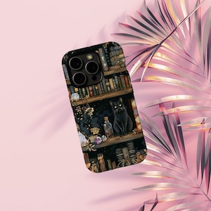 May include: Black phone case featuring a detailed illustration of a black cat sitting on a bookshelf filled with books, bottles, and crystals. The design has a dark, mystical theme with a vintage aesthetic.