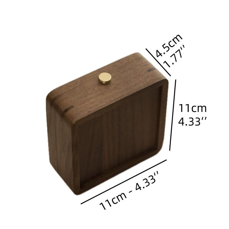 May include: A rectangular wooden box with rounded corners, featuring a brass knob. The box is 4.33 inches long, 4.33 inches wide, and 1.77 inches tall. The wood has a dark brown color.