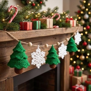 May include: A festive Christmas garland featuring crocheted green Christmas trees and white snowflakes, strung with wooden beads. The garland is displayed on a wooden mantelpiece decorated with gifts, candy canes, and a Christmas tree.