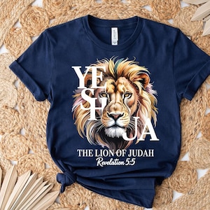 A navy blue t-shirt with a graphic design featuring a lion's head and the text "YES HAYA" and "THE LION OF JUDAH" printed on it.