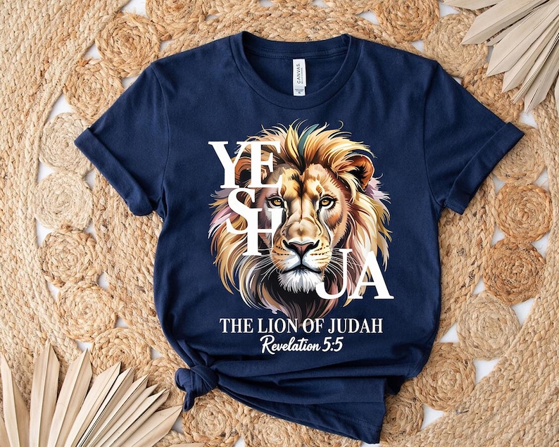 A navy blue t-shirt with a graphic design featuring a lion's head and the text "YES HAYA" and "THE LION OF JUDAH" printed on it.