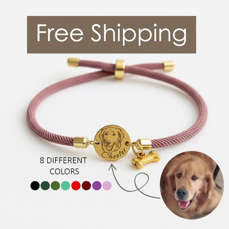 May include: A mauve adjustable cord bracelet featuring a gold-toned circular charm engraved with a dog portrait and the name Chester, accompanied by a small gold-toned bone-shaped charm. The design includes gold-toned metal end caps and a sliding bead.