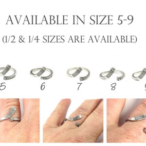 May include: Five silver rings in sizes 5 through 9, each shaped like a hockey stick. The rings are shown on a white background. The text "AVAILABLE IN SIZE 5-9 (1/2 & 1/4 SIZES ARE AVAILABLE)" is above the rings.