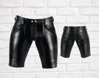 May include: Two pairs of black leather shorts with zipper details. One pair has a zipper fly and the other has a button closure.