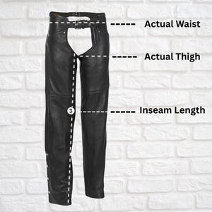 May include: Black leather chaps with a belt and buckle. The chaps have a fringe detail on the sides. Measurements are shown for waist, thigh, and inseam length.