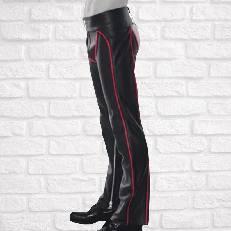 May include: Black leather pants with red stitching and a zipper detail on the side seams.