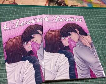 May include: Two pink and white comic books with the title "Clean" on the cover. The cover features a couple with pink and white hair. The couple is drawn in a manga style.