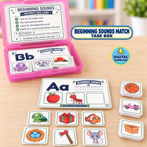 May include: A pink plastic storage box containing educational cards for a beginning sounds matching game. The set includes instruction cards, letter cards like Bb and Aa, and small square picture cards featuring items like an apple, ant, and turtle.