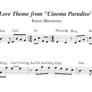 Puede incluir: Partitura de "Love Theme from Cinema Paradiso" de Ennio Morricone. La partitura está escrita en tinta negra sobre fondo blanco. El título y el nombre del compositor están en la parte superior, con notas, claves y acordes.
