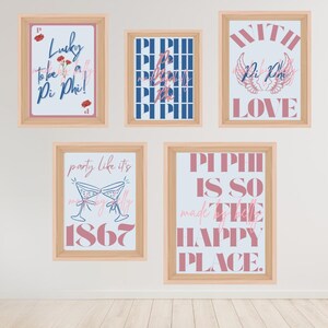 May include: Five framed prints with light wood frames. The prints feature text and graphics in pink and blue. One print says "Lucky to be a Pi Phi!" Another says "With Love Pi Phi". The other prints have text.