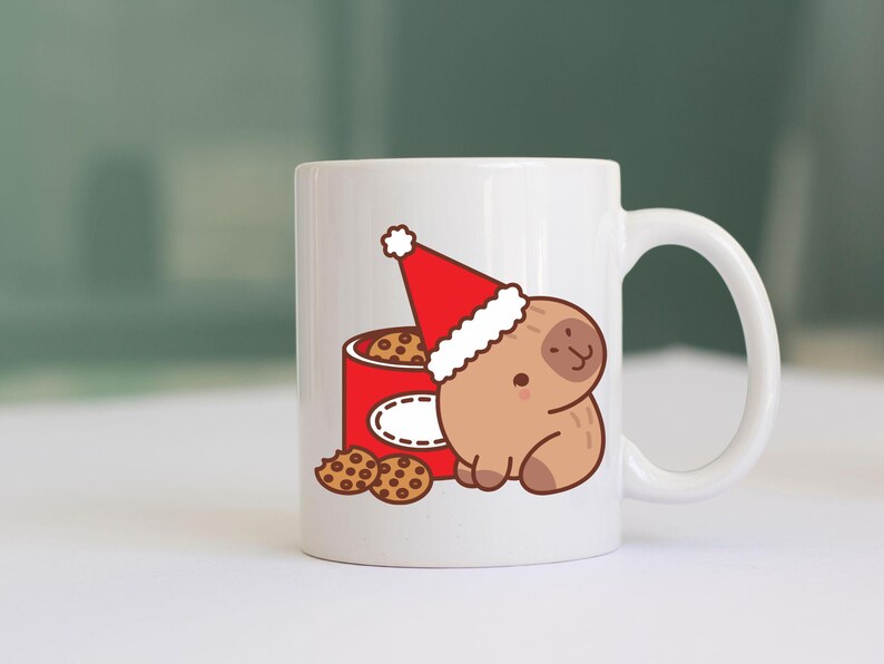 May include: White ceramic mug featuring a cartoon sloth wearing a Santa hat, next to a red cookie tin. The tin is filled with cookies, and a few cookies are scattered in front. A festive holiday design.
