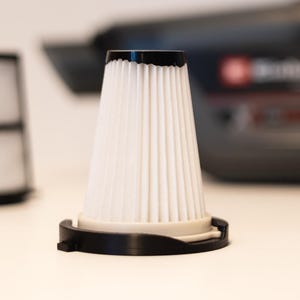 May include: A handheld vacuum cleaner in black and red with two replacement filters. One filter is a white pleated cone with a black base, and the other is a white mesh cylinder with a black frame, both positioned in front of the vacuum.