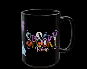 May include: Black ceramic mug with the words "Spooky Vibes" in a colorful, Halloween-themed design. The design includes ghosts, a black cat, a raven, and a jack-o'-lantern. The mug has a large handle and is perfect for enjoying your favorite beverage during the spooky season.