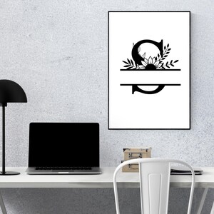 May include: A black and white printable design featuring the letter "S" with a sunflower and leaves. The letter is split in half with a line, creating a space for a name or word.