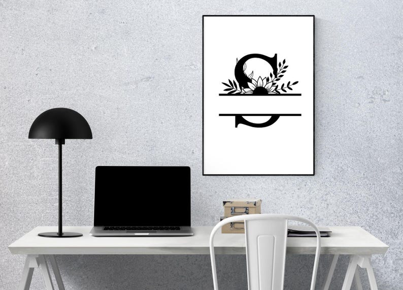 May include: A black and white printable design featuring the letter "S" with a sunflower and leaves. The letter is split in half with a line, creating a space for a name or word.