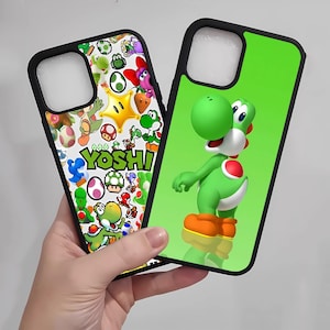 May include: Two phone cases with black borders. One case features a green Yoshi character on a green background. The other case has a white background with various Yoshi-themed graphics and the word "YOSHI".